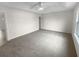 Spacious bedroom with soft carpeting, a ceiling fan, and ample natural light at 328 Village Ln, Stockbridge, GA 30281