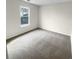 Bedroom featuring neutral carpet and a window at 328 Village Ln, Stockbridge, GA 30281