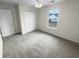 Bright bedroom with neutral carpet, ceiling fan, window, and closet with folding doors at 328 Village Ln, Stockbridge, GA 30281