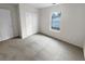 Bright bedroom with neutral carpet, window, and closet with folding doors at 328 Village Ln, Stockbridge, GA 30281