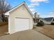 Single Gathering home featuring a two-car garage and partial brick facade at 328 Village Ln, Stockbridge, GA 30281