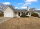 Charming single-story home with a cozy front porch and attached garage at 328 Village Ln, Stockbridge, GA 30281