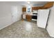 Efficient kitchen with wood cabinets, standard appliances, and practical flooring at 328 Village Ln, Stockbridge, GA 30281