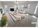 Bright living room features a fireplace, neutral decor, and plush seating, creating a welcoming space at 328 Village Ln, Stockbridge, GA 30281