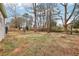 A wide shot shows the spacious, tree-lined backyard with a fire pit sitting area and fencing at 456 Pretty View Se Ln, Smyrna, GA 30082