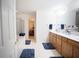 Bathroom featuring dual sinks, a shower with glass doors, and a neutral color palette at 6674 Mimosa Cir, Tucker, GA 30084