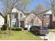 Charming two-story brick home featuring an attached two-car garage and well-manicured front lawn at 6674 Mimosa Cir, Tucker, GA 30084