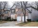 A brick and siding house features a two-car garage, well-maintained landscaping, and a classic architectural design at 6674 Mimosa Cir, Tucker, GA 30084