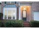 Charming brick home showcasing a well-manicured front yard and inviting front entrance at 6674 Mimosa Cir, Tucker, GA 30084
