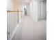 Hallway with carpet flooring and wood banister at 6674 Mimosa Cir, Tucker, GA 30084
