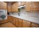 Traditional kitchen featuring wood cabinets, white countertops, and a microwave/oven combo at 6674 Mimosa Cir, Tucker, GA 30084