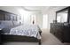 This spacious bedroom offers tray ceilings, neutral carpet, a wooden bed frame, and a connecting doorway at 6674 Mimosa Cir, Tucker, GA 30084