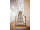 Carpeted staircase with wooden banister and white walls at 6674 Mimosa Cir, Tucker, GA 30084