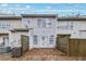 Back exterior view of the home with a small fenced yard and patio at 4878 Hairston Park Sq, Stone Mountain, GA 30083