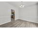 Dining area with sleek floors, chandelier, and open view to a kitchen at 4878 Hairston Park Sq, Stone Mountain, GA 30083