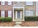 Inviting front entrance with a gray front door, complemented by manicured landscaping at 4878 Hairston Park Sq, Stone Mountain, GA 30083