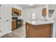 Galley kitchen has white countertops, wood cabinets, and black appliances at 4878 Hairston Park Sq, Stone Mountain, GA 30083