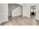 Open-concept living room with new floors, connecting to a staircase and kitchen at 4878 Hairston Park Sq, Stone Mountain, GA 30083