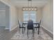 Dining room with modern light fixture, dining table, and view to the hall at 701 Jefferson Drive, Conyers, GA 30014