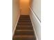Carpeted Stairway in neutral tones with white railing at 8170 Oakley Cir, Union City, GA 30291