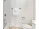 Bright bathroom with a tiled shower/tub, toilet, and towel rack at 201 16Th Nw St # 4, Atlanta, GA 30363