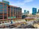 Urban landscape showcases a blend of modern architecture and city skyline views, with a clear blue sky above at 201 16Th Nw St # 4, Atlanta, GA 30363