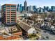 A dynamic city view featuring buildings and a skyline, framed by residential rooftops and lush trees at 201 16Th Nw St # 4, Atlanta, GA 30363