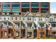 Row of townhomes with brick and stone accents beneath a modern glass and brick building at 201 16Th Nw St # 4, Atlanta, GA 30363