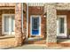 Charming townhome front entrance with brick and stone accents, featuring a vibrant blue door and two entryways at 201 16Th Nw St # 4, Atlanta, GA 30363