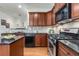 Stylish kitchen features stainless steel appliances, dark countertops, and wooden cabinets at 201 16Th Nw St # 4, Atlanta, GA 30363