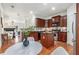 Modern kitchen with cherry cabinets, granite countertops, and stainless steel appliances at 201 16Th Nw St # 4, Atlanta, GA 30363