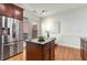 Charming kitchen features a central island with black countertops and stainless steel refrigerator at 201 16Th Nw St # 4, Atlanta, GA 30363