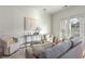 Living room with neutral furniture, stylish decor, and doors to an outdoor space at 201 16Th Nw St # 4, Atlanta, GA 30363