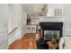 Cozy living room with a fireplace, hardwood floors, and views to kitchen at 201 16Th Nw St # 4, Atlanta, GA 30363