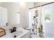 A bathroom featuring a shower/tub combo, decorative shower curtain and decorative mirror at 2163 Ben Hill Rd, Atlanta, GA 30344