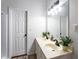 Bright bathroom featuring a double vanity, modern lighting, and decorative plants at 2163 Ben Hill Rd, Atlanta, GA 30344