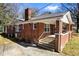 Quaint red brick house with a welcoming front porch and classic architectural details, a true gem at 2163 Ben Hill Rd, Atlanta, GA 30344