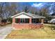 Charming brick home featuring a cozy front porch and well-maintained yard, perfect for suburban living at 2163 Ben Hill Rd, Atlanta, GA 30344