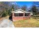 Charming brick home featuring a cozy front porch and well-maintained yard, perfect for suburban living at 2163 Ben Hill Rd, Atlanta, GA 30344