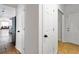 Hallway featuring white doors and an entrance into a living room at 2163 Ben Hill Rd, Atlanta, GA 30344