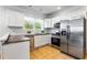 Well-equipped kitchen with stainless steel appliances, white cabinets, and ample counter space at 2163 Ben Hill Rd, Atlanta, GA 30344