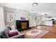 Bright living room with hardwood floors, a decorative fireplace, and a comfortable gray couch at 2163 Ben Hill Rd, Atlanta, GA 30344