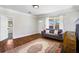 Sunlit living room featuring hardwood floors, a cozy sofa, and a decorative fireplace at 2163 Ben Hill Rd, Atlanta, GA 30344