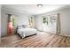 Spacious main bedroom featuring wood-look flooring and three large windows at 2163 Ben Hill Rd, Atlanta, GA 30344