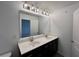 Bathroom featuring a double sink vanity, large mirror, and modern lighting at 2105 Stillhaven Pl, Douglasville, GA 30135