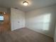 Neutral bedroom featuring plush carpeting, closet, and a sunlit window at 2105 Stillhaven Pl, Douglasville, GA 30135