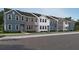 Row of new two-story townhomes, each with varied facade colors and unique architectural details at 2105 Stillhaven Pl, Douglasville, GA 30135