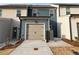 Charming townhome showcasing a beige garage door and blue siding at 2105 Stillhaven Pl, Douglasville, GA 30135
