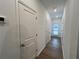 Hallway with white trim, doors, and wood-look flooring at 2105 Stillhaven Pl, Douglasville, GA 30135