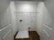 Laundry room with white walls, wire shelving, and a wood-look floor at 2105 Stillhaven Pl, Douglasville, GA 30135
